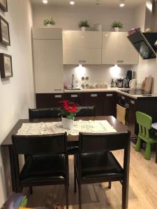 a kitchen with a dining room table with black chairs at Mieszkanie Serce Natury w Polanicy Zdrój in Polanica-Zdrój