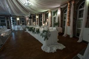 a wedding reception with a white tent and tables at Meifod country house hotel in Caernarfon