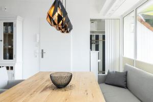 a dining room with a table and a couch at Golfresidenz Wohnung 211 in Grömitz