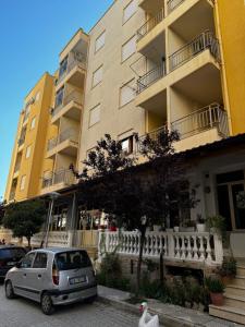 a small car parked in front of a building at Amles Apartment in Vlorë
