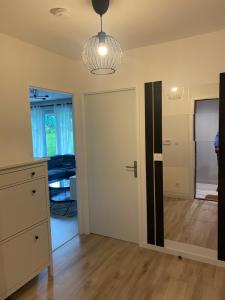 a living room with a door and a bedroom at Le chic de Villiers Sur Marne in Villiers-sur-Marne