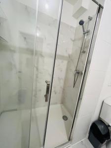 a shower with a glass door in a bathroom at Le chic de Villiers Sur Marne in Villiers-sur-Marne