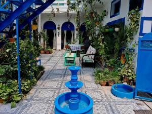 a greenhouse with a blue vase in the middle at The Coral House Homestay by the Taj in Agra