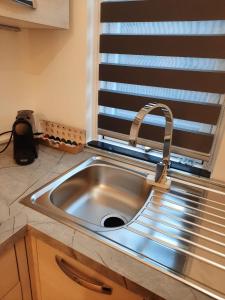 a stainless steel sink in a kitchen with a window at n&ghomesweethome RaffaelloElegante appartamento ideale casa vacanze affari in Milan +51 photos