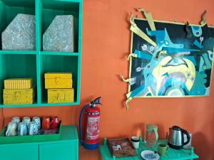 a room with green cabinets and a painting on the wall at The Coral House Homestay by the Taj in Agra