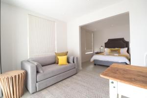 a living room with a couch and a bed at Kestrel Apartments in Paternoster