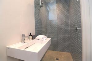 a bathroom with a sink and a shower at Kestrel Apartments in Paternoster +27 photos