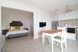 a kitchen and a bedroom with a bed and a table at Kestrel Apartments in Paternoster