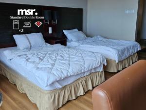 A bed or beds in a room at Kota Kinabalu City Ensuite at SCSP Ming Garden