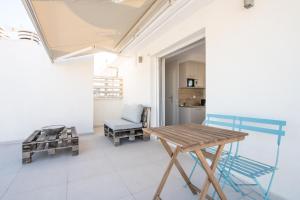 a room with a wooden table and a chair at RoofTop Sea View Cabin in Vari