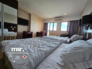 A bed or beds in a room at Kota Kinabalu City Ensuite at SCSP Ming Garden