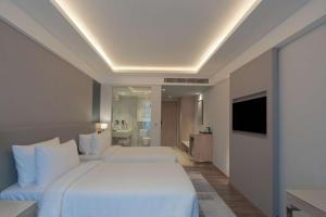 a hotel room with two beds and a television at Park Inn by Radisson Ayodhya in Ayodhya