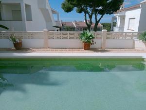 a swimming pool in front of a house at AT Chalet Stella con Piscina Privada in Peniscola