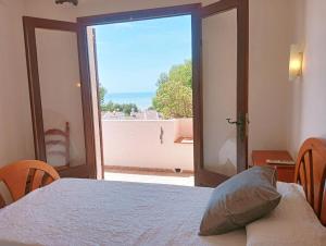 a bedroom with a bed and a view of the ocean at AT Chalet Stella con Piscina Privada in Peniscola +40 photos