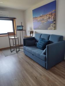 a blue couch sitting in a living room at Casa MIRA DOURO in Vila Nova de Gaia