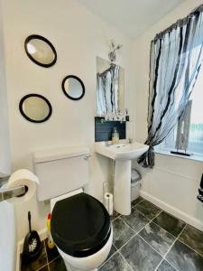 a bathroom with a toilet and a sink at Vaila Guest House in Aberdeen +50 photos