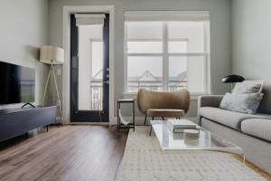 a living room with a couch and a table at Blueground Lost Plains parking gym pool wd ATX-261 in Austin