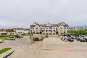 a parking lot in front of a large building at Blueground Lost Plains parking gym pool wd ATX-261 in Austin