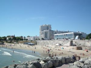 a group of people on a beach near the water at Appartement à royan in Royan +13 photos