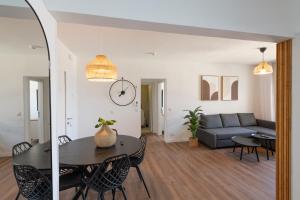 a living room with a table and a couch at Eilat Luxury Vacation -Amazing Pool in Eilat