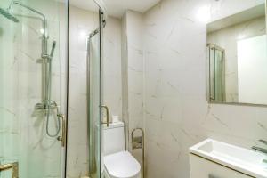 a bathroom with a shower and a toilet and a sink at SL Marbella in Marbella +46 photos