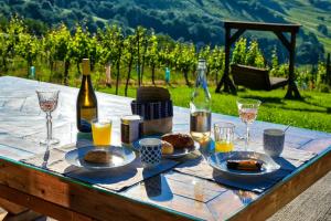 a table with food and glasses of wine on it at Kellerstöckl am Berg in Eisenberg an der Pinka