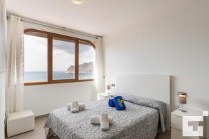 a bedroom with a bed and a large window at Villa Mirador de Bassetes 14 - Grupo Turis in Calpe +40 photos