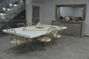 a dining room table with chairs and a mirror at Atlas Royale Marrakech in Marrakesh