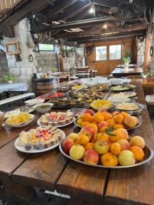 a table with many plates of food on it at Skadar lake Apartments Pajovic in Virpazar