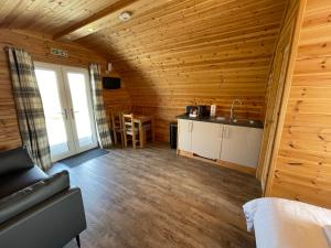 a room with a kitchen and a living room at Glenview Lodge in Portree