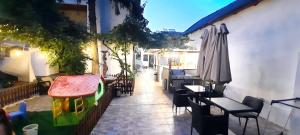 a patio with a toy house and a table and an umbrella at Vila Beatrix in Eforie Nord