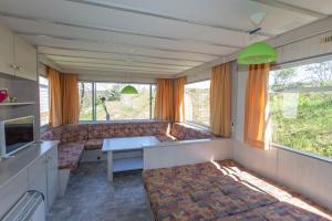 a living room with a couch and a table at Bungalow, Adler auf Rügen in Zirkow