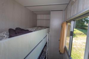 a small room with a bed and a window at Bungalow, Adler auf Rügen in Zirkow