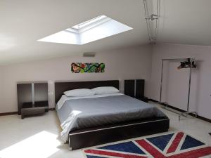 a bedroom with a large bed with a skylight at You Welcome Apt in Elmas