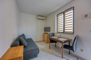 a living room with a couch and a table at Apartments Punta in Poreč