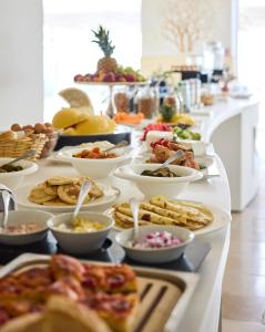 a buffet line with many different types of food at La Casa E Il Mare, Private Bay Hotel in Mattinata