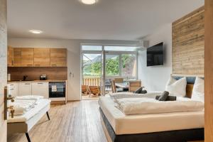 een woonkamer met twee bedden en een keuken bij Natur Residenz Bad Häring in Bad Häring