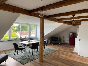 a living room with a dining room table and chairs at Sahr Appartements in Kulmbach