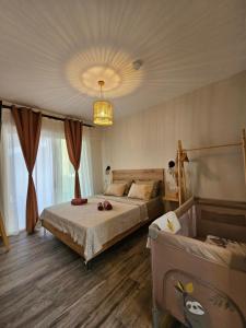 a bedroom with two beds and a chandelier at Marivar living in Nea Fokea