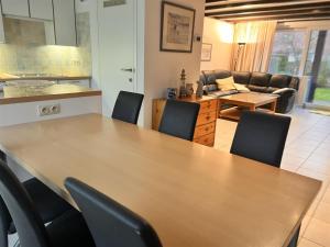 a kitchen and living room with a table and chairs at Barkas 18 in Nieuwpoort +4 photos
