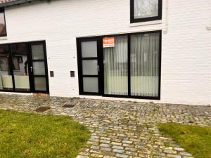 a building with black doors and windows on it at Barkas 18 in Nieuwpoort