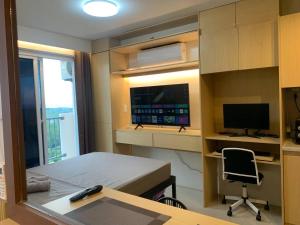 una habitación con una cama y un escritorio con una computadora en work & chill 깨끗한 compact studio, en Lapu Lapu City