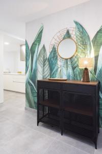 a mirror on a dresser in a room with a mural at Home2Book Design & Spacious Apartment City Center in Santa Cruz de Tenerife