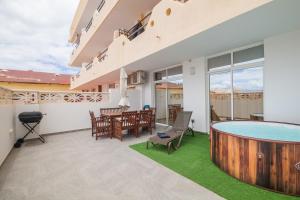 a patio with a table and chairs and a dining room at Playa Paraiso apartment in Playa Paraiso