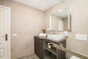a bathroom with a sink and a mirror at Playa Paraiso apartment in Playa Paraiso +17 photos