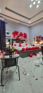 a room with a bed with red flowers on the floor at Mboka Village in Kahama