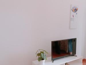 a flat screen tv sitting on top of a white shelf at Casa Nahara in Puerto del Rosario