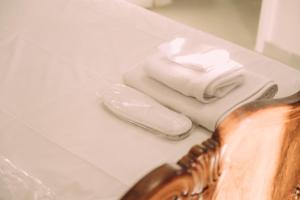 a pile of towels sitting on top of a bathroom counter at Sirens Luxury Apartments Palouki in Palouki +45 photos