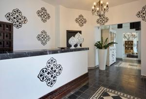 a lobby with black and white stencils on the walls at La Casa E Il Mare, Private Bay Hotel in Mattinata