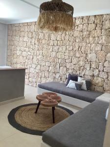 a living room with a couch and a table at Almyra Boutique Suites with Private Pool -Finiki in Foinikion +32 photos